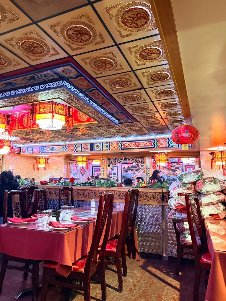 Ornate red and gold ceiling with paper lanterns inside Pagoda